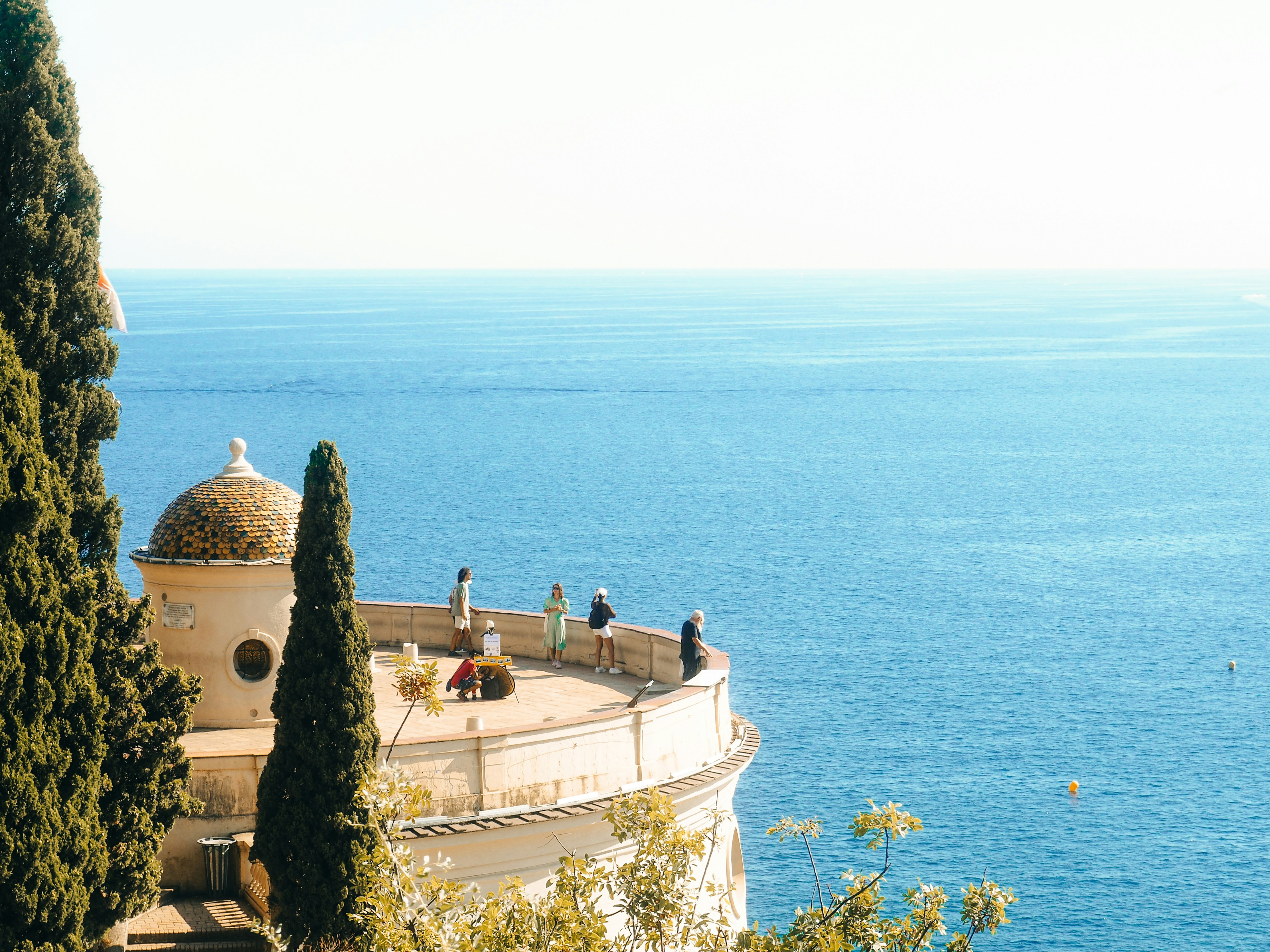 Travellers overlooking the Mediterranean coast